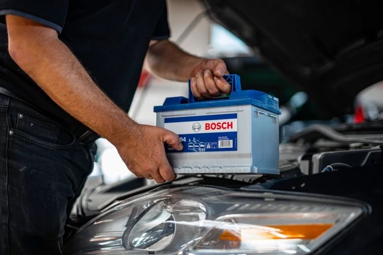 Monteur van Accupech24 monteert een nieuwe Bosch auto-accu op locatie